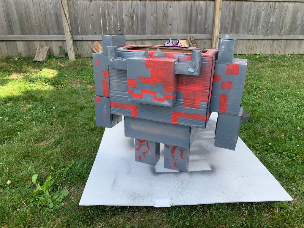 Fully assembled Redstone Monstrosity piñata with color blocking as a guide for tissue paper fringe.